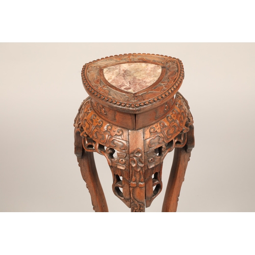 625 - Carved Chinese Jardiniere stand with rouge marble insert with carved apron mounted on three legs, he... 