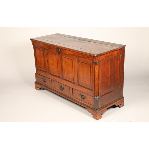 633 - Georgian oak coffer, hinged top over a four panelled front above three fitted base drawers, length 1... 