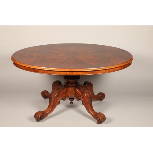 639 - Victorian walnut oval tip up breakfast table on central column on quadraform legs, length 135cm, hei... 