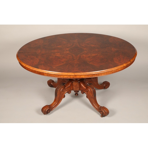 639 - Victorian walnut oval tip up breakfast table on central column on quadraform legs, length 135cm, hei... 