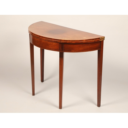 640 - Mahogany demi lune fold over tea table raised on square tapered legs, length 88cm, width 43cm, heigh... 