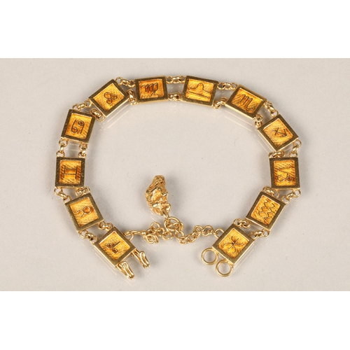 82 - Ladies unmarked yellow metal bracelet with symbols with an attached gold nugget pendant, length 19cm... 