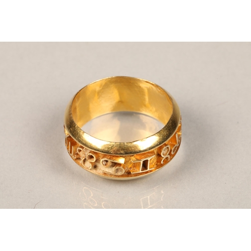 84 - Ladies unmarked yellow metal ring, decorated with symbols, weight 5.5g, ring size P