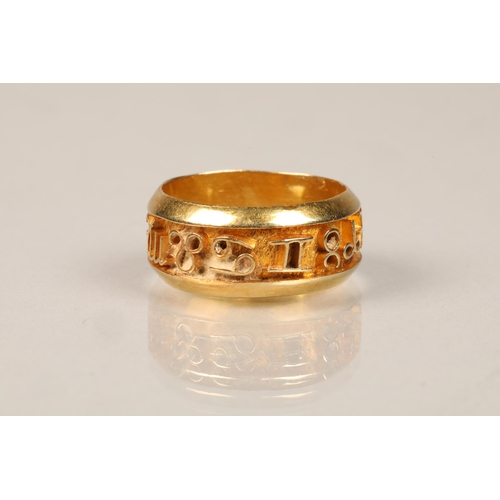 84 - Ladies unmarked yellow metal ring, decorated with symbols, weight 5.5g, ring size P