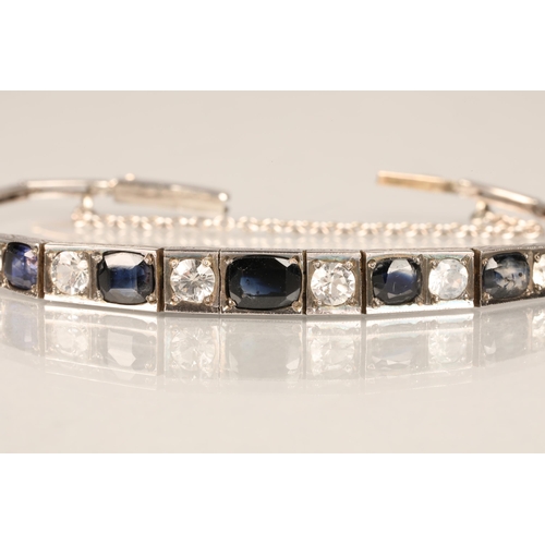 85 - Ladies white metal sapphire bracelet, graduated blue sapphires, interspersed with white sapphires, s... 