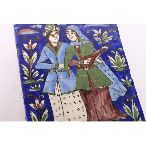 150 - Iznik Persian Qajar period plaque depicting a man and a woman, 24cm x 17cm. (a/f) #188