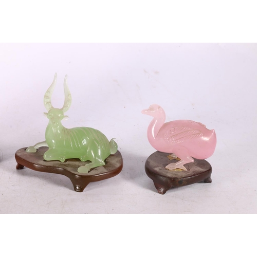 202 - Peking glass pink goose, a Peking green glass deer, a green hardstone Tang style horse, and a jade t... 