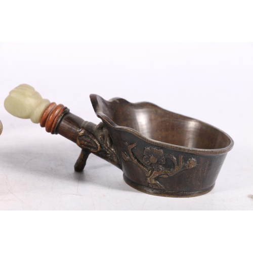 211 - Chinese bronze spoon warmer or iron with lotus petal rim, 24cm long, and two smaller drinking vessel... 