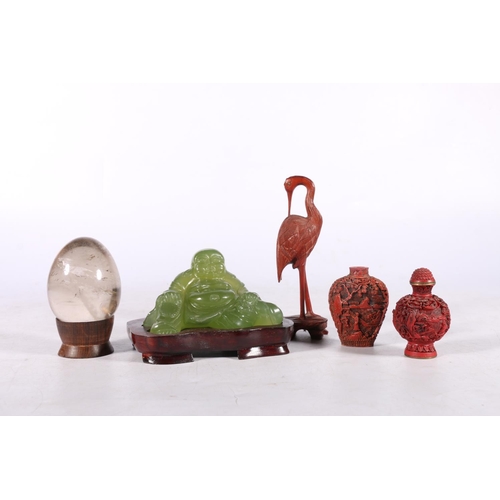 221 - Oriental decorative items comprising a Peking glass Buddha on stand 12cm wide, a rock crystal egg on... 