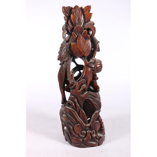 222 - Chinese root wood carving modelled as a Kylin and peacock fighting, 31cm high.