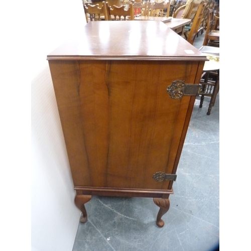 420 - Mahogany two-door cabinet with ornate hinges, on cabriole supports.