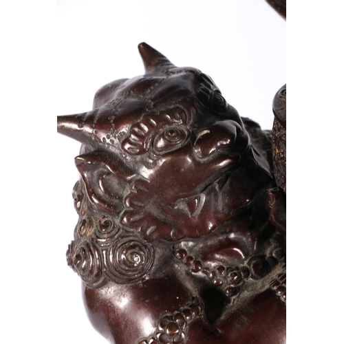 191 - Japanese bronze figure of a devil (Oni) holding a winged bowl, possibly a censer, 78cm high. #486