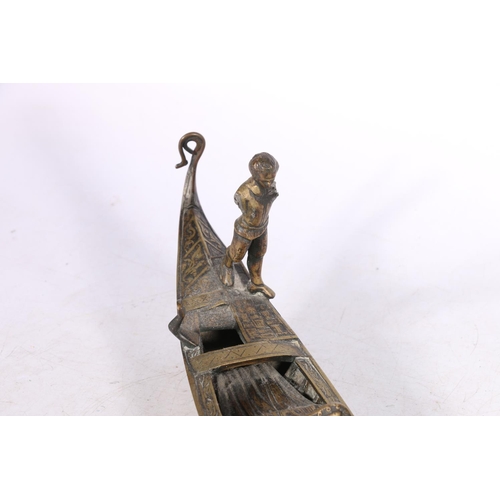 241 - Cast bronze model of a gondola with standing figure, 50cm long, and another.  (2)