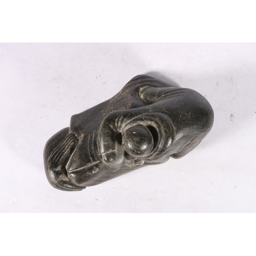 243 - Canadian Inuit serpentine or soapstone carving of a hunter with seal, 29cm long.