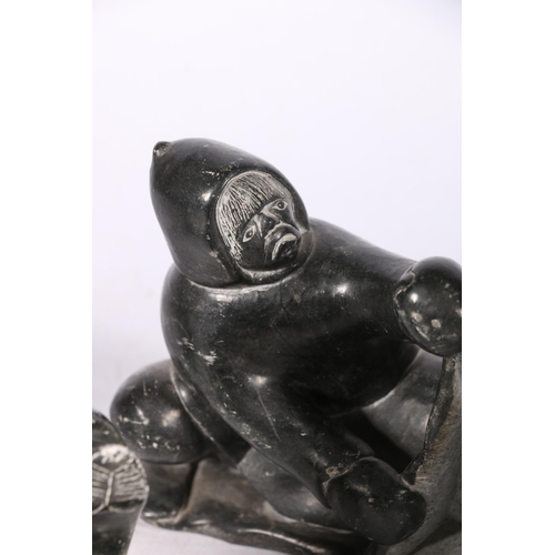 244 - Five Canadian Innuit soapstone or serpentine carvings comprising a hunter with tent, a kneeling figu... 