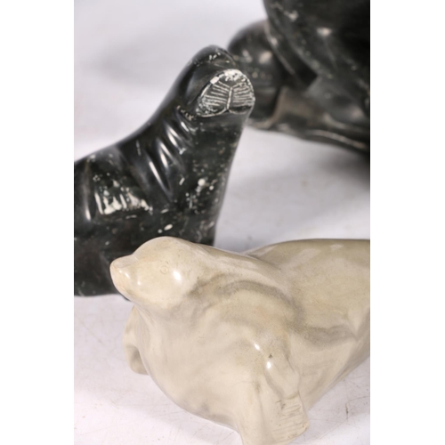 244 - Five Canadian Innuit soapstone or serpentine carvings comprising a hunter with tent, a kneeling figu... 