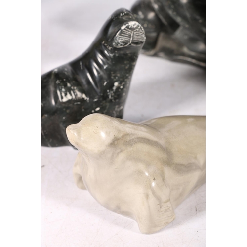 244 - Five Canadian Innuit soapstone or serpentine carvings comprising a hunter with tent, a kneeling figu... 