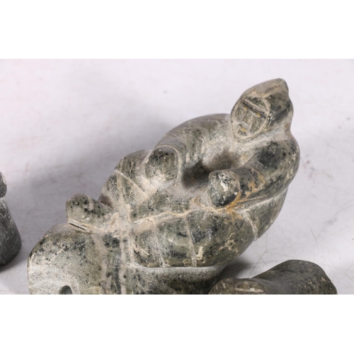 245A - Three Canadian or Inuit soapstone carvings, one of a man on sled, 12cm long, and two others.  (3)  #... 