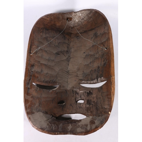 247 - Large African carved dark indigenous wood mask in the form of a face, with further face flanked by m... 