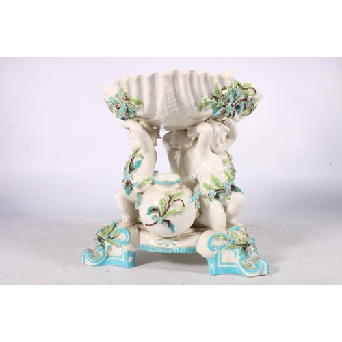 254 - Minton pedestal bowl modelled as three cherubs holding a scallop shell aloft, white porcelain with g... 