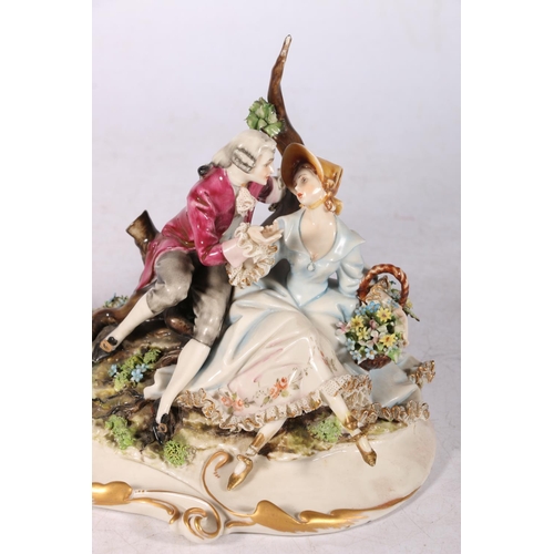 257 - Volkstedt porcelain figure group of lovers with basket of flowers, in 18th century dress, 14cm high,... 