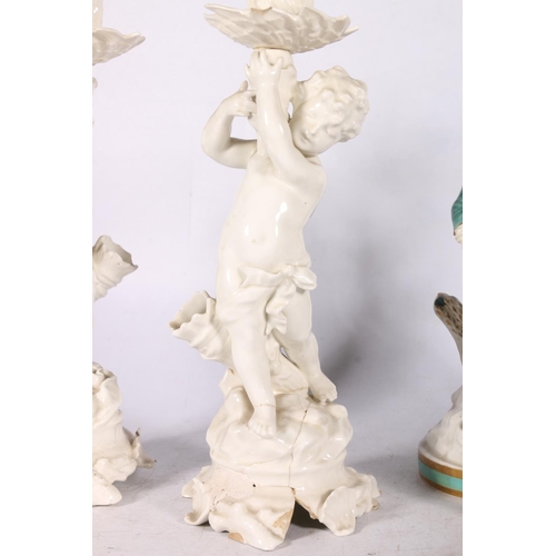 263 - Porcelain figure of a boy with a dog, 22cm high, a pair of white glazed figural candlesticks and fou... 