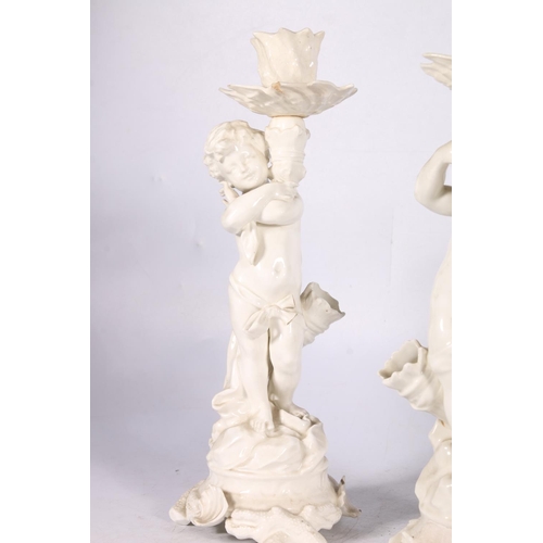 263 - Porcelain figure of a boy with a dog, 22cm high, a pair of white glazed figural candlesticks and fou... 