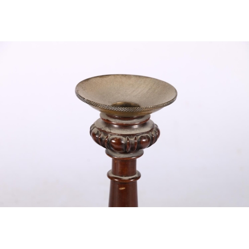 277 - Pair of turned mahogany loaded candlesticks, with brass drip trays, 21cm high.  #196