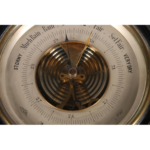 294 - Circular bulkhead barometer in ebonised frame, 27cm diameter.