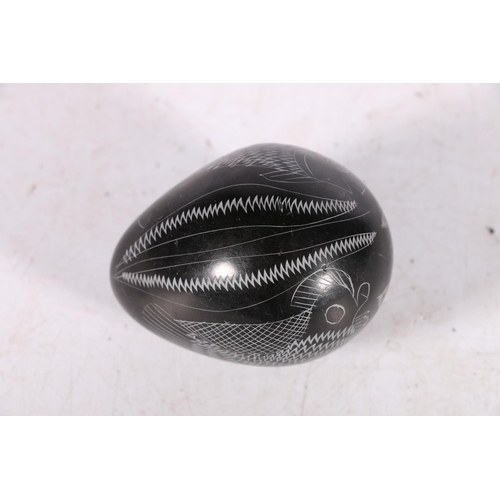 259 - Carved Inuit black stone egg decorated with chicken and fish, 6cm long.  #70