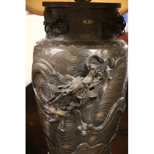 141 - Japanese bronze vase table lamp, relief dragon decoration, with yellow shade, 91cm high. #64