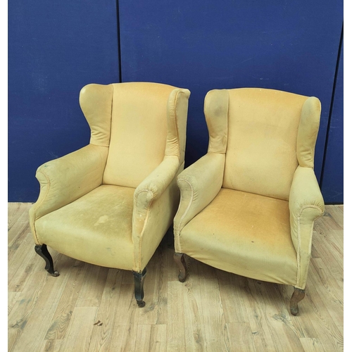 385 - Pair of early 20th century wing back armchairs upholstered in later mustard colour velour, On cabrio... 