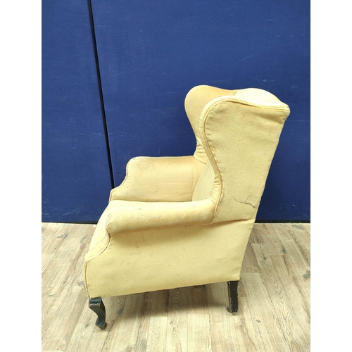 385 - Pair of early 20th century wing back armchairs upholstered in later mustard colour velour, On cabrio... 