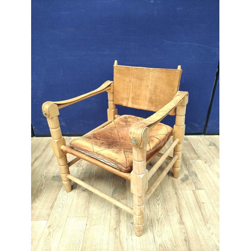 388 - Pair of 20th century Indian easy chairs of teak construction with stretched leather back and arm res... 