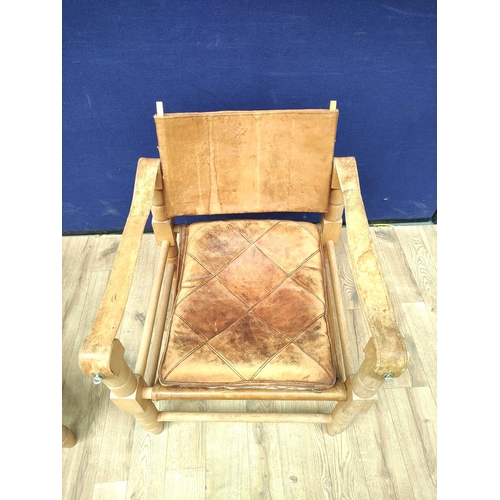 388 - Pair of 20th century Indian easy chairs of teak construction with stretched leather back and arm res... 