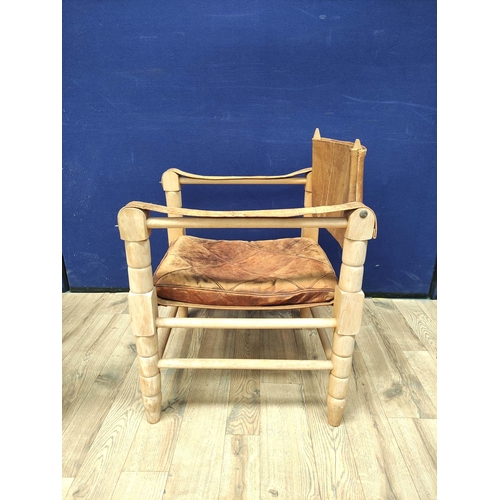 388 - Pair of 20th century Indian easy chairs of teak construction with stretched leather back and arm res... 