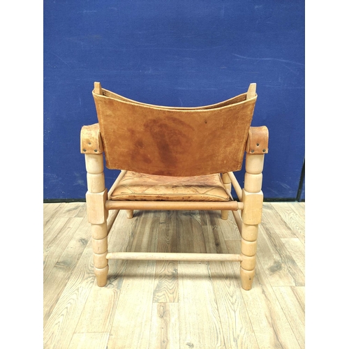 388 - Pair of 20th century Indian easy chairs of teak construction with stretched leather back and arm res... 