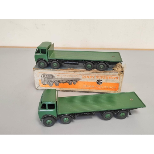 19 - Dinky Toys. A boxed Foden Flat Truck no 502 with dark green cab and bed. Also another similar loose.... 