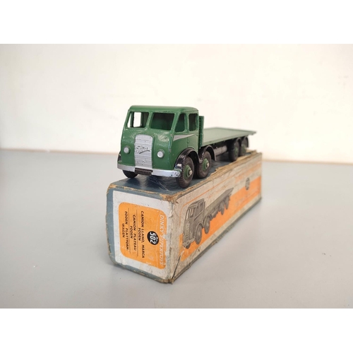 19 - Dinky Toys. A boxed Foden Flat Truck no 502 with dark green cab and bed. Also another similar loose.... 