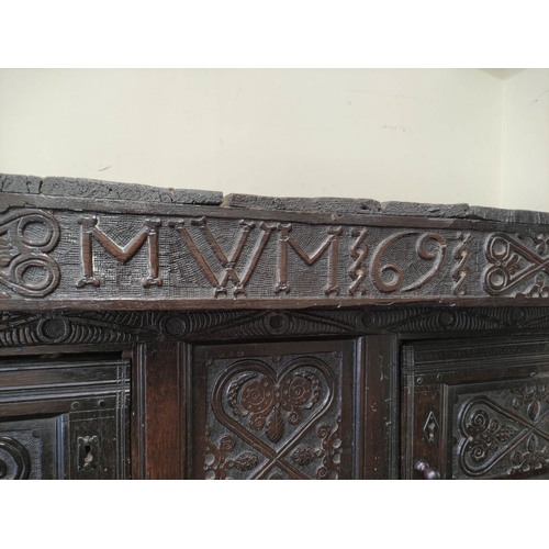 374 - Antique oak court cupboard inscribed to the frieze with initials and dated 1691, above foliate carvi... 