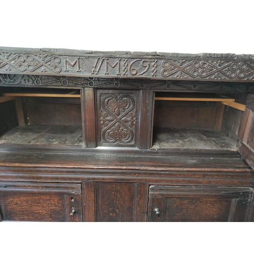 374 - Antique oak court cupboard inscribed to the frieze with initials and dated 1691, above foliate carvi... 