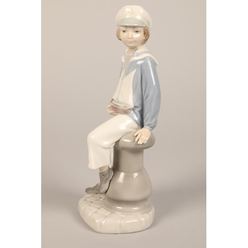 5 - Lladro figure of a girl, 31 cm high , Lladro sailor boy with boat, 23 cm high (2)