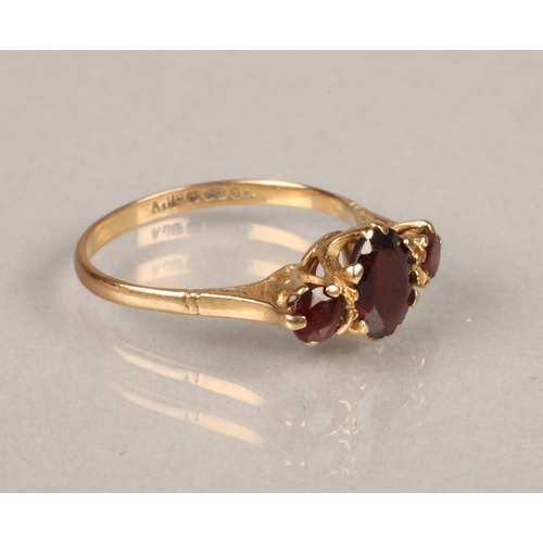 66 - 9ct yellow gold ring set with three red stones. Size: O