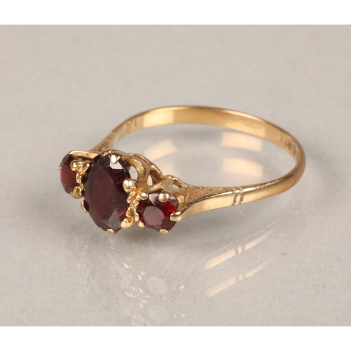 66 - 9ct yellow gold ring set with three red stones. Size: O