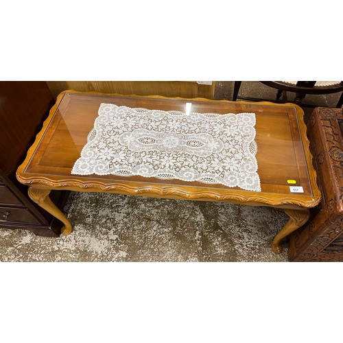 557 - Glass topped vintage coffee table