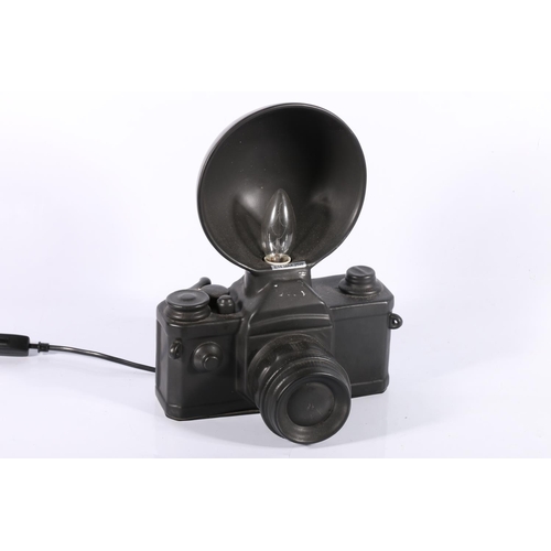 104 - Novelty table lamp in the form of a camera, 31cm high.