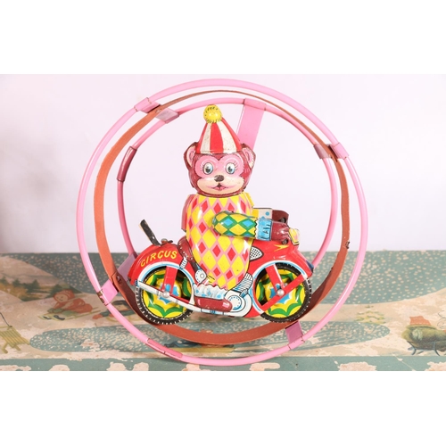 12 - Vintage tinplate and other toys to include a spinning top, a Japanese clockwork circus toy, a space ... 