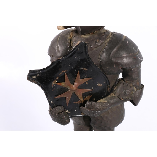 76 - Miniature tin model of a knight in suit of armour, 34cm.