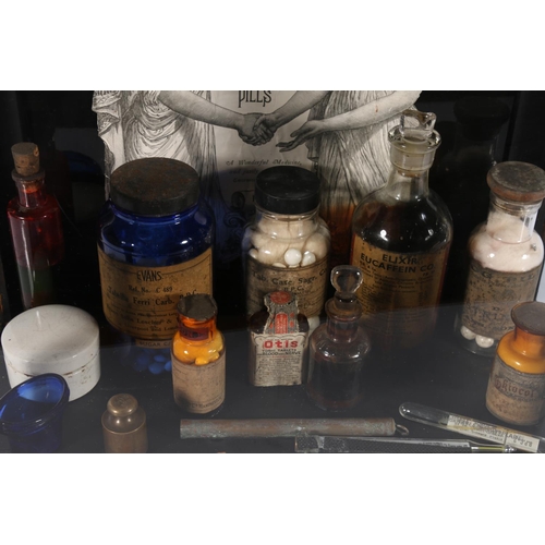 77 - Collection of medical items, arranged within glass display case, case measures 38cm high.