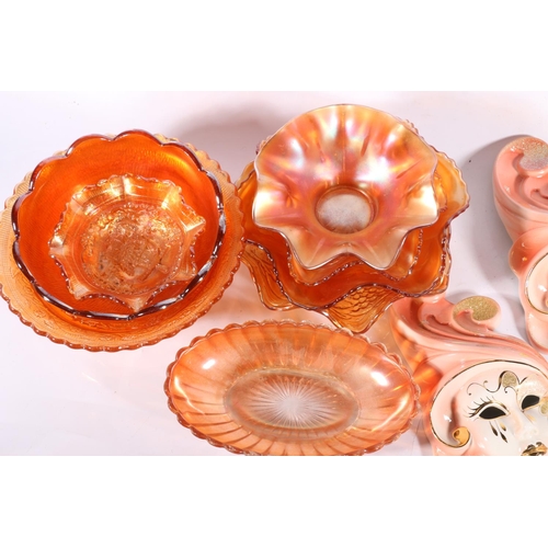 93 - Eight pieces of Carnival glass and a set of three graduated ceramic wall masks.